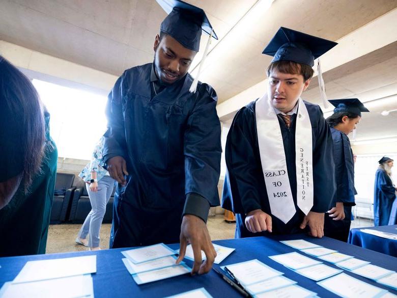 two students at commencement 